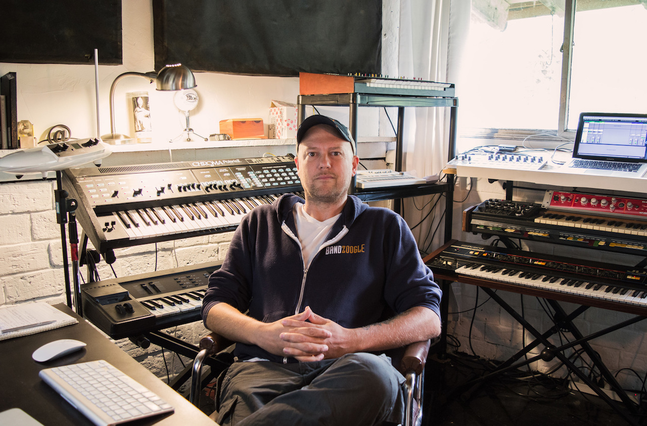 Bandzoogle's Technical Support Manager, Adam, sits in his at-home production studio.